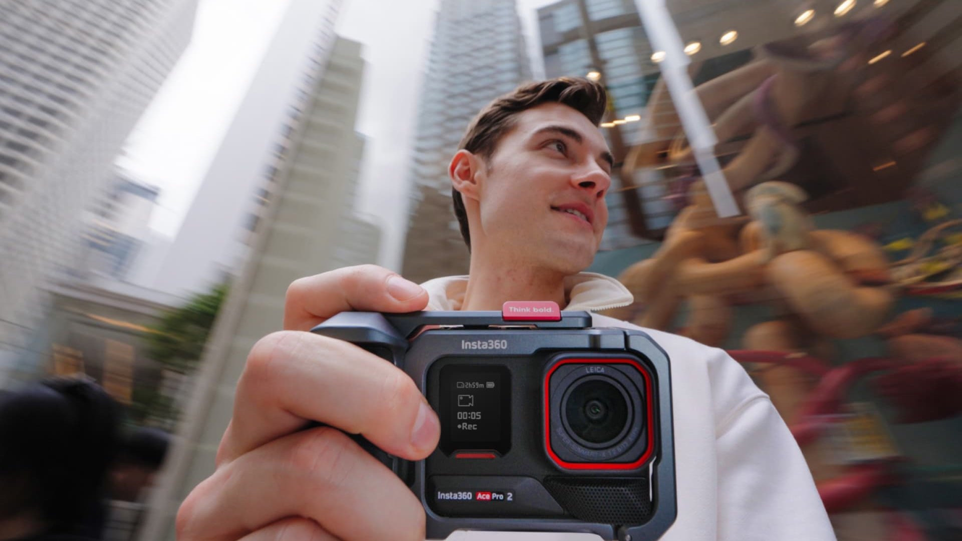 Creator filming handheld in the city with the Insta360 Ace Pro 2