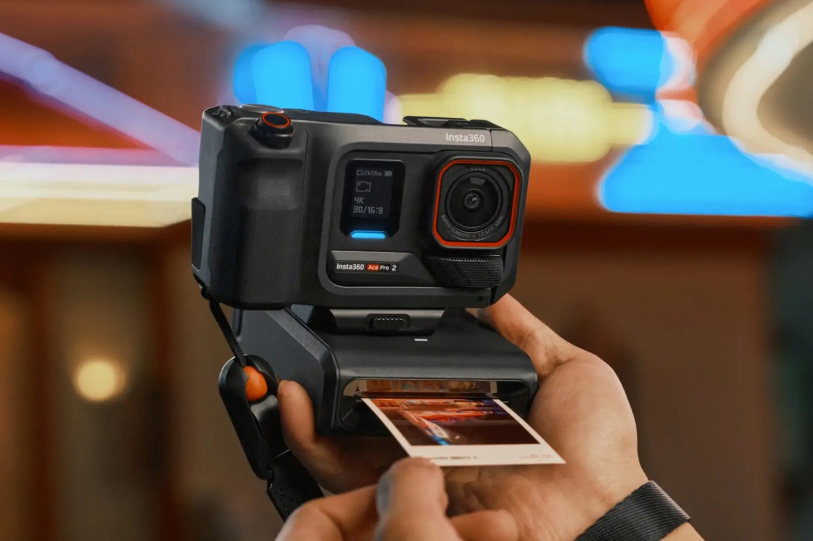 Ace Pro 2 on the instant photo printer accessory in a neon-lit street