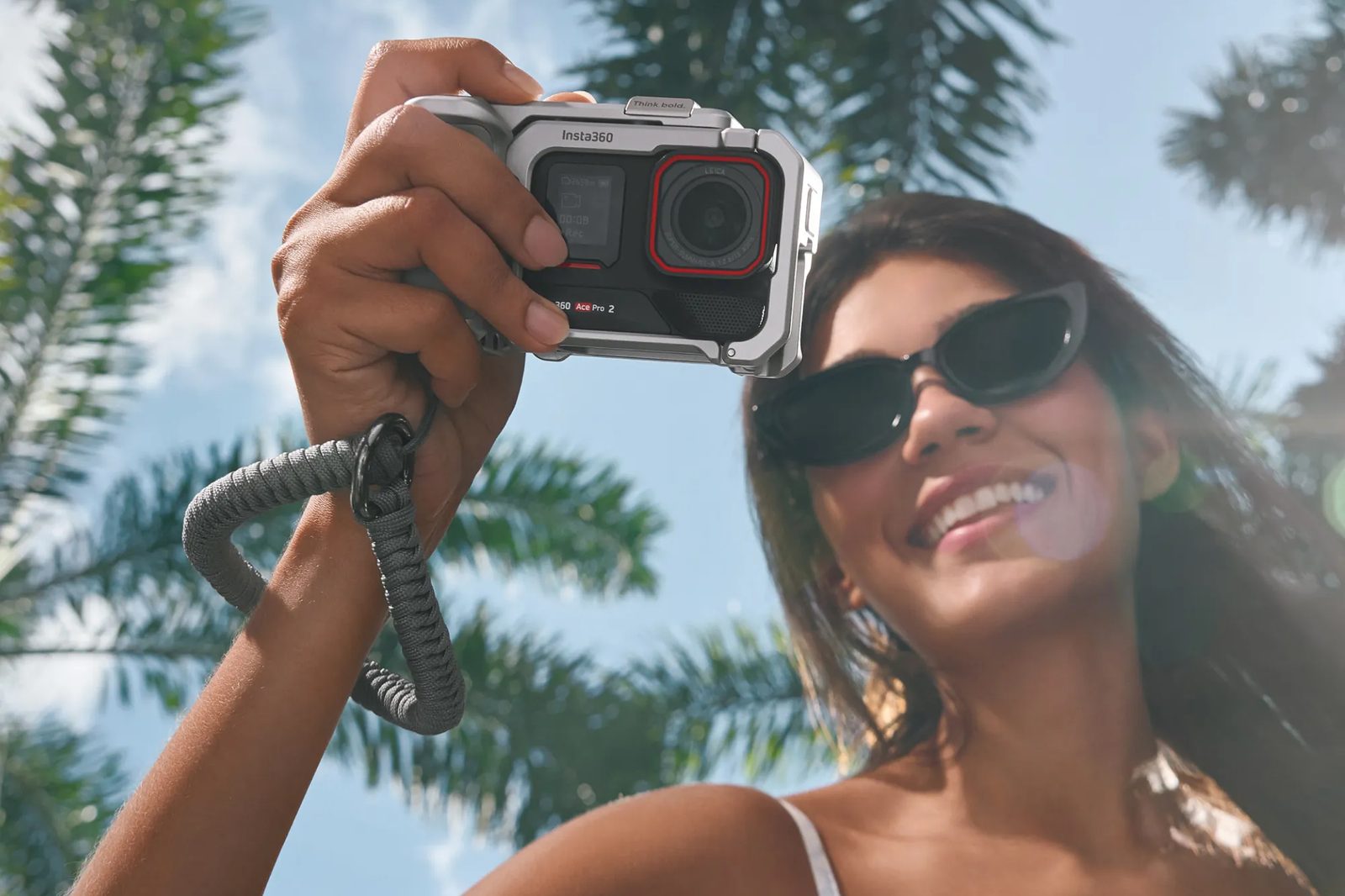 Ace Pro 2 held up against palm trees and blue sky