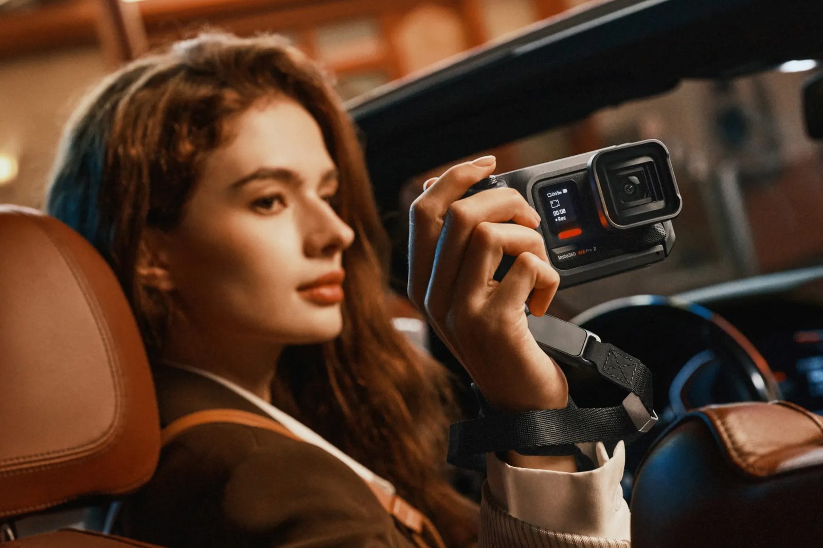Ace Pro 2 filming in neon-lit low light from a car at night